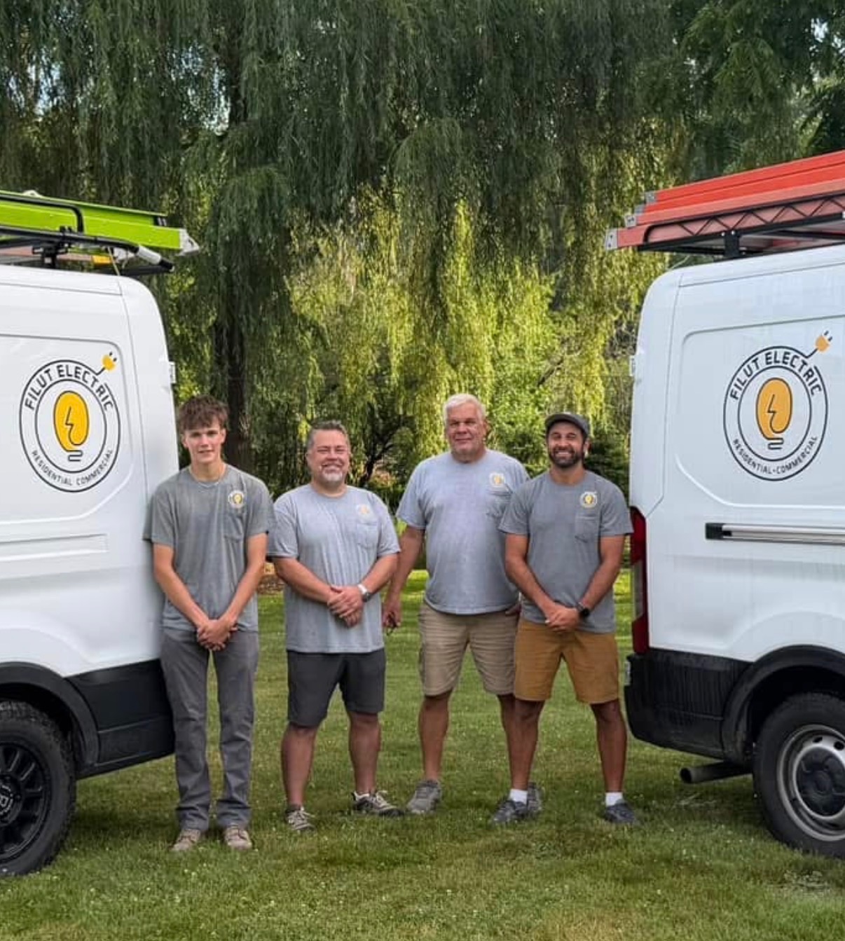 Filut Electric team in front of service vans